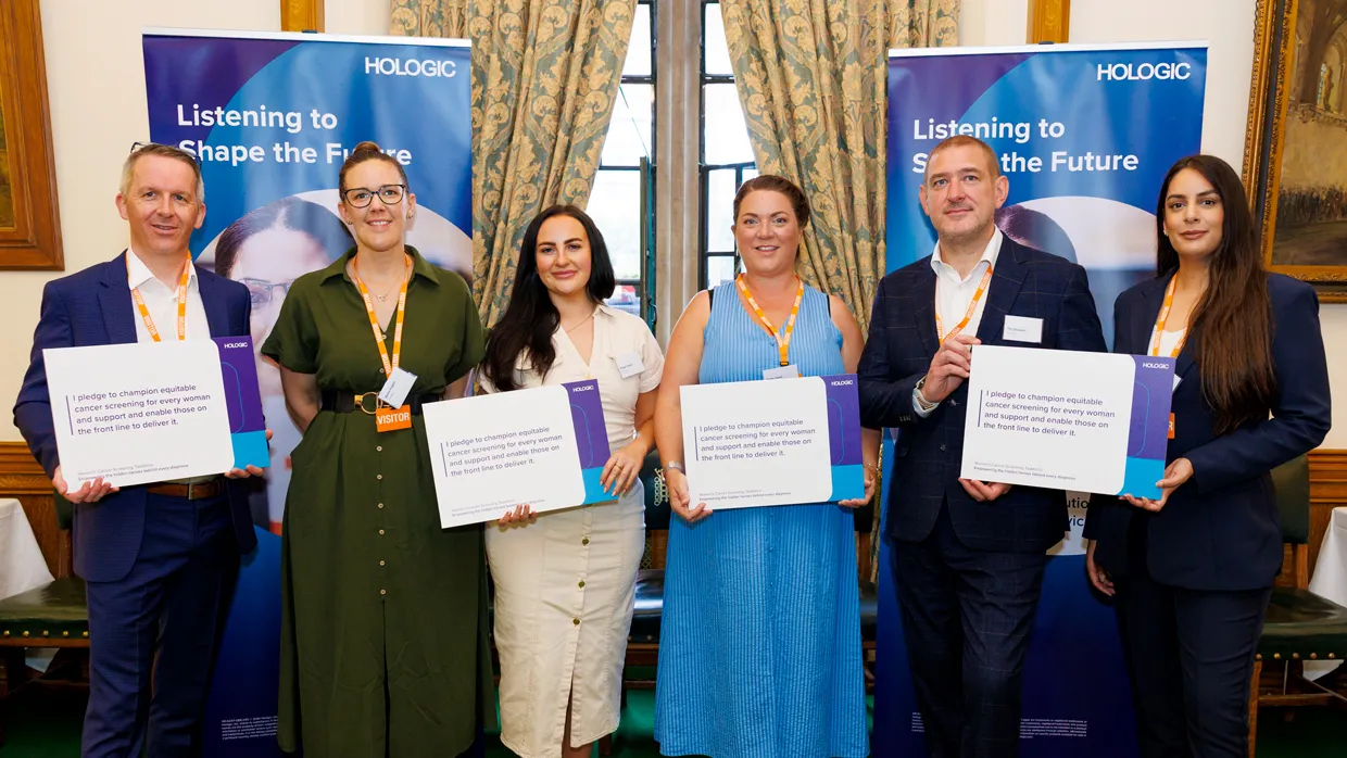 Group of people holding text cards and smiling at camera