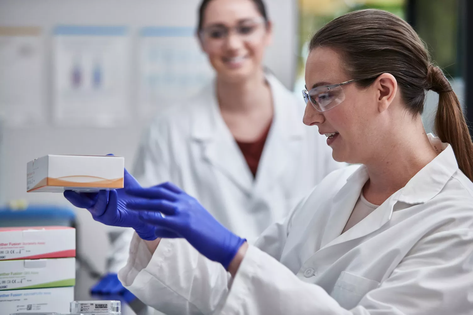 Lab technician arranging Assay Boxes in lab setting